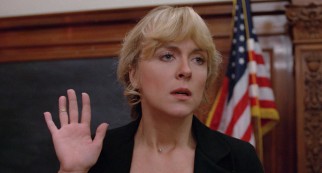 Taking over New Deal in the wake of her father's death, estranged daughter Barbara Fuchs (Deborah Harmon) finds herself in court on false advertising charges the morning after a doctored commercial airs.