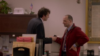 Gary (Tony Hale) dons a woman's coat to retrieve a mis-signed sympathy card from Jonah (Timothy Simons), the White House's tall, unpopular liaison to the VP, in the series premiere.