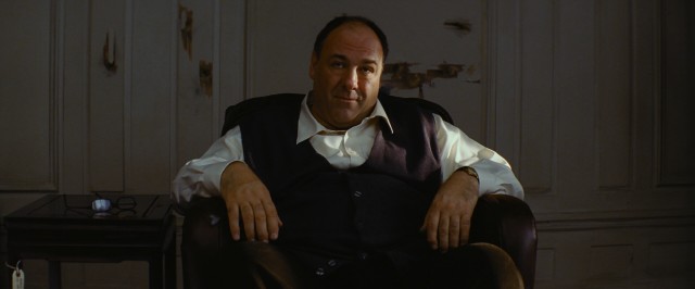 With bullet holes around but not in him, The Guy (James Gandolfini) awaits the fate he's accepted.