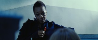 1990s Academy Award nominee Marianne Jean-Baptiste appears briefly as the lollipop-twirling, advice-dispatching top-ranked assassin in Violet and Daisy's outfit.