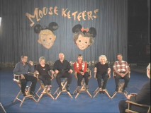 Six of the original Mouseketeers gather in front of the show's curtain and remember "The Leader of the Club."