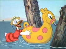 Donald torments Pluto with an inflatable seahorse in "Beach Picnic"