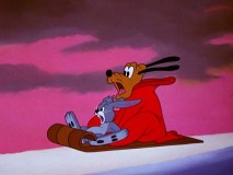Pluto and a Rabbit slide dangerously down a hill in "Mail Dog."