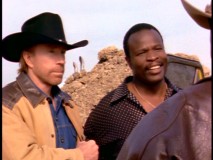 Walker holds drug trafficking suspect The Panther (Grand L. Bush) just moments before the latter is given an uncharacteristic punch from his younger brother, Jimmy Trivette.