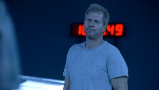 CDC doctor Edwin Jenner (Noah Emmerich) extends some hospitality to his guests, but disaster looms, as the ominous red countdown clock suggests.