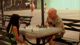 Boris (Larry David) berates one of his chess students for not making a smart move.