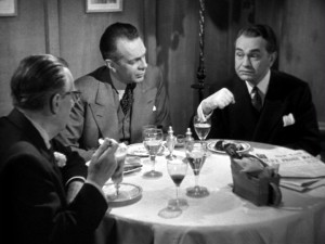 With a show of his scratched wrist, Richard suggests his own guilt to his D.A. (Raymond Massey) and doctor (Edmond Breon) friends.