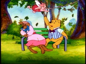 Playing Cupid, an out-of-control Piglet swoops above Kanga and Pooh in an unplanned part of the gang's living Valentine for Christopher Robin.