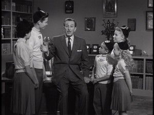 Walt's time at the "Disneyland" desk gets interrupted by some Mouseketeers in "The Fourth Anniversary Show."