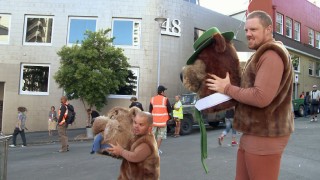 Two New Zealanders -- one short, one tall -- stand in for Boo Boo and Yogi Bear with furry brown costumes and handheld character heads.