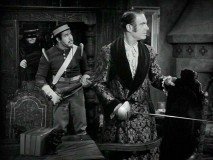 A frightened Administrado and on-duty Corporal Reyes look out for the sources of nighttime disturbances, while Zorro sneaks up behind them.