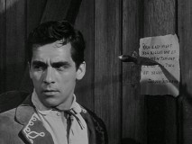 Joaquin Castenada (Perry Lopez) posts a declaration of revenge against Rico.