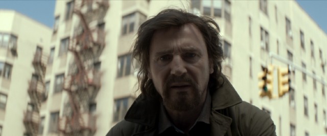 Liam Neeson sports a different look playing Scudder as an off-duty cop in the film's 1991-set prologue.
