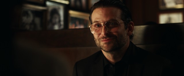 Bradley Cooper reunites with his "Hangover" director both as a "War Dogs" producer and as scene-stealing watch-listed businessman Henry Girard.