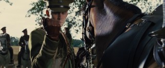 Captain Nicholls (Tom Hiddleston) admires the colored sash that comes with his new horse.