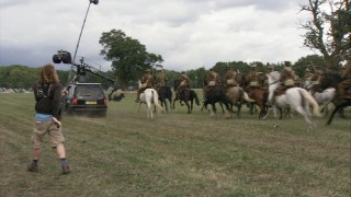 A camera mounted on a Mercedes and a crew member with a boom mic capture a calvalry's charge in "A Filmmaking Journey."