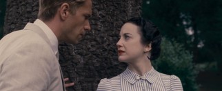 The monarchy-shaking love affair of Edward VIII (James D'Arcy) and Wallis Simpson (Andrea Riseborough) is of tremendous interest to both this film and its modern-day protagonist.