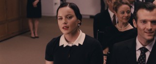 Wally (Abbie Cornish) dresses up nice and bids the hell out of Wallis Simpson's old gloves.