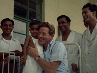 Danny Kaye poses with a sick foreign child in the 1955 UNICEF short film "Assignment Children."