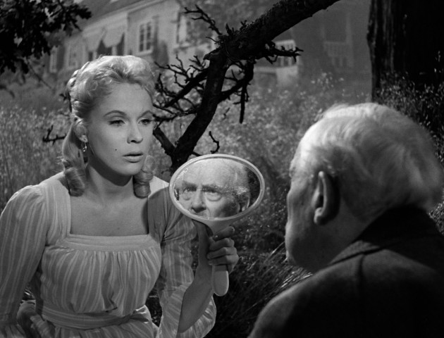 Cousin Sara (Bibi Andersson) holds up a mirror to show Professor Isak Borg (Victor Sjstrm) his old self in Ingmar Bergman's "Wild Strawberries."