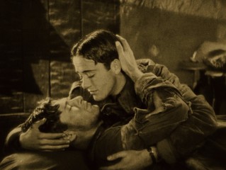 This scene between Jack (Charles "Buddy" Rogers) and David (Richard Arlen) includes one of cinema's first same-sex kisses, but there's nothing gay about it.