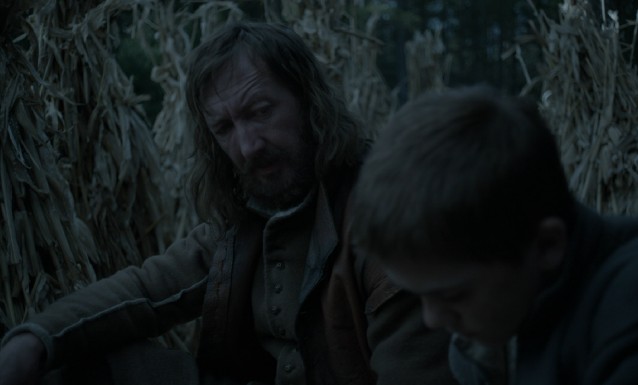 On a hunt, William (Ralph Ineson) and Caleb (Harvey Scrimshaw) discuss the whereabouts of missing baby Jonathan's soul.