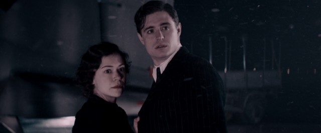 In a 1940s flashback, the young Maria Altmann (Tatiana Maslany) and her husband (Max Irons) fear an obstacle as they are about to board a plane for Cologne, France.