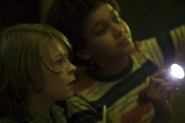 Ben (Oakes Fegley) and Jamie (Jaden Michael) use a flashlight to explore the American Museum of Natural History after dark in "Wonderstruck."