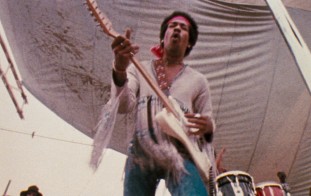 Jimi Hendrix brings Woodstock into a fourth day of peace and music with his concert-closing Monday morning performance to a significantly diminished crowd.