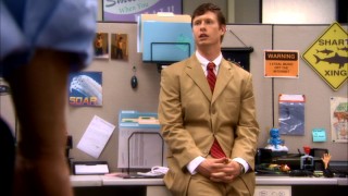Anders' (Anders Holm) push for a promotion includes wearing this wrinkled tan suit and promising a PowerPoint presentation.