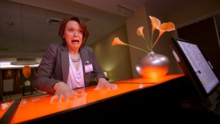 Tripping on acid, Alice (Maribeth Monroe) finds the concierge desk made of Jell-O.
