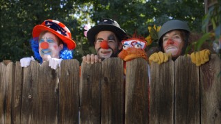 Made up as clowns, the guys check out their children's party entertainment competition.