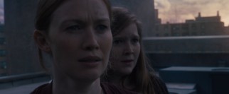 Awaiting rescue atop a Newark apartment building, Karin (Mireille Enos) and Rachel (Abigail Hargrove) worry about their husband and father, respectively.