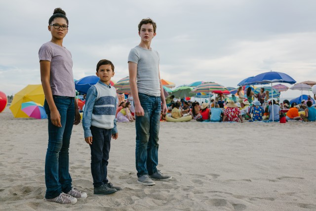 Meg (Storm Reid), Charles Wallace (Deric McCabe), and Calvin (Levi Miller) get transported from a suburban daymare to a colorful beach in Disney's "A Wrinkle in Time."
