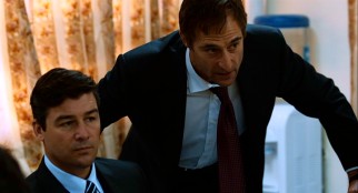 George (Mark Strong) reminds Maya's station chief Joseph Bradley (Kyle Chandler) and others of the high costs and limited progress of the CIA's investigation.