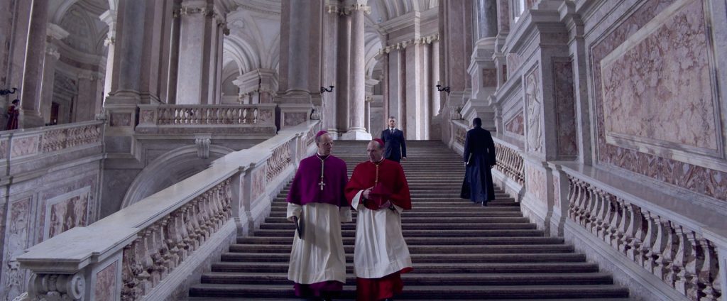 Two cardinals take a walk downstairs in Edward Berger's immersive Vatican drama "Conclave."